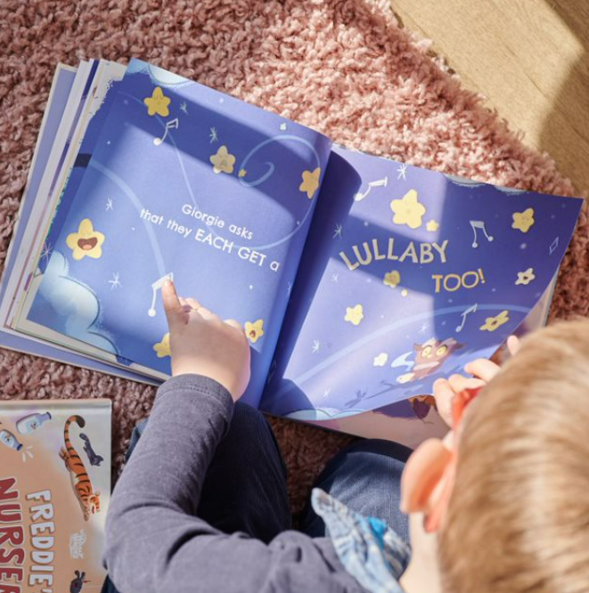 A boy reads his very own custom going to bed book.