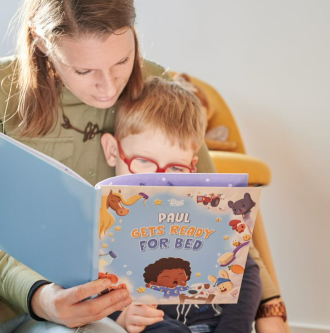 Mother and child read a personalized bedtime book just for them.