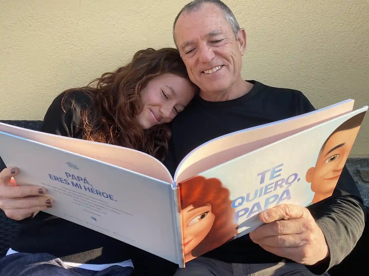 A daddy reading a personalized book for adults with his daughter.