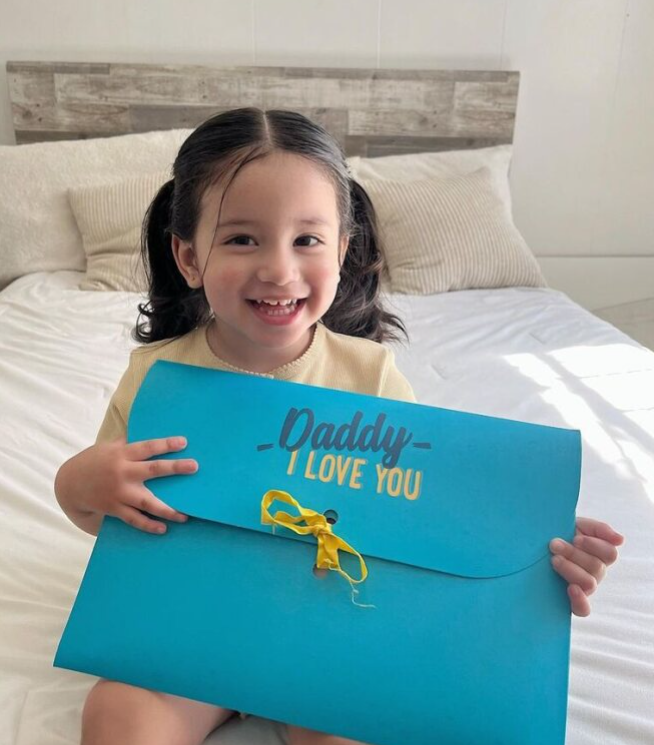 A little girl about to offer the best Father's Day gift idea to her Dad.