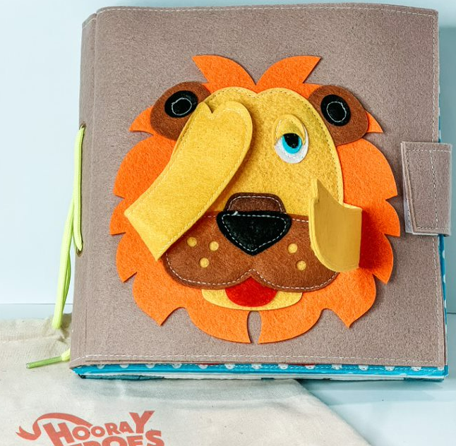 A lion covered activity book that can be customized with the child's name.